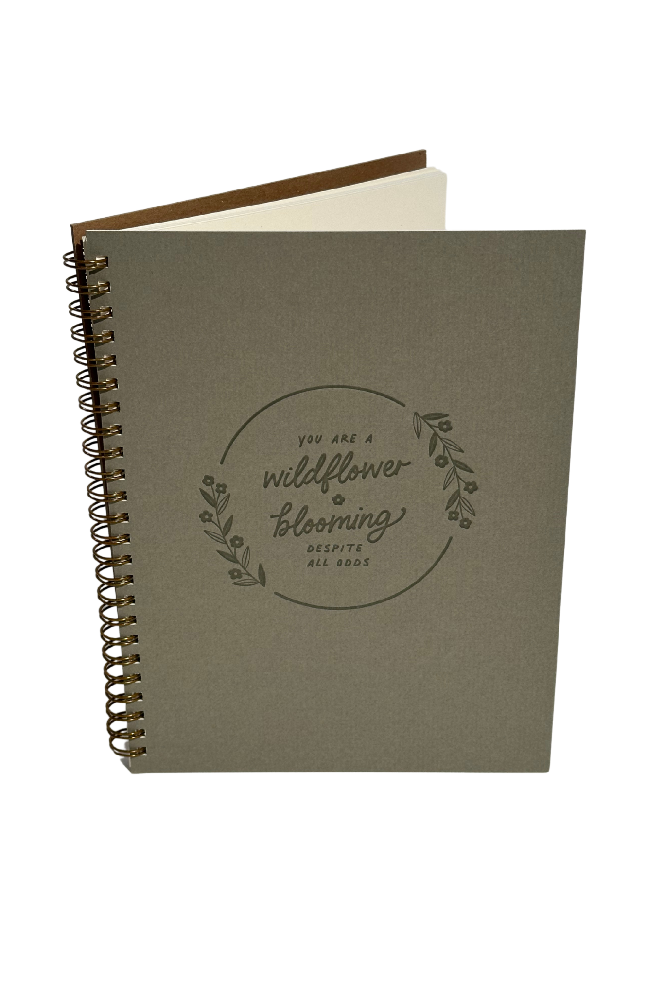 A Wildflower Blooming Journal with a nature-inspired cover that reads “You are a wildflower, blooming despite all odds,” featuring 70 lined pages and bronze wire-O binding.