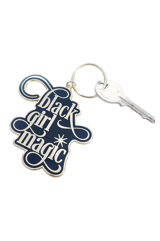 Black Girl Magic enamel keychain with a glossy finish, brass key ring, and charm, measuring 2.75 inches long.